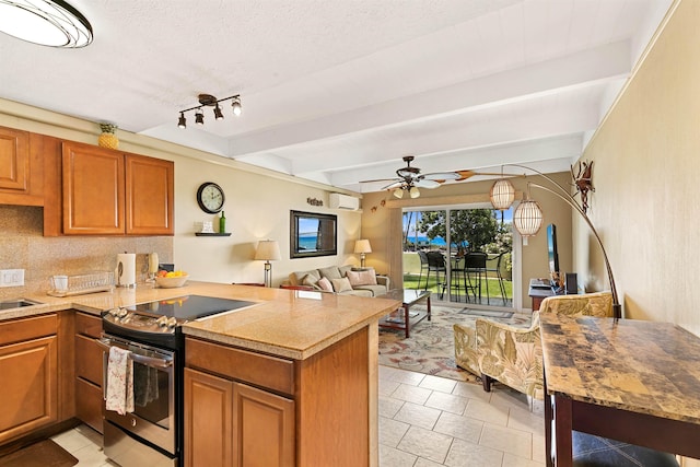 kitchen featuring kitchen peninsula, stainless steel range with electric stovetop, and ceiling fan