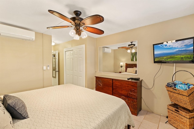 tiled bedroom featuring a wall mounted air conditioner, a closet, and ceiling fan