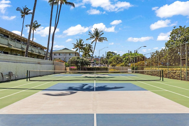 view of tennis court featuring basketball hoop