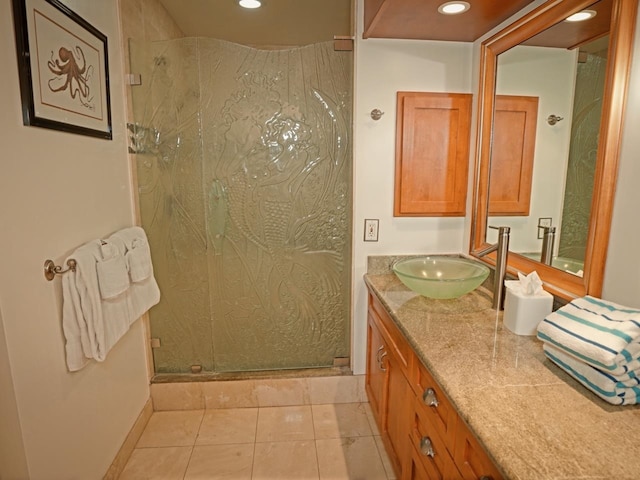 bathroom featuring a shower with door, tile floors, and large vanity