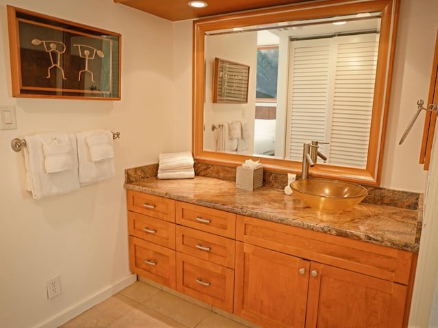 bathroom featuring vanity with extensive cabinet space and tile flooring