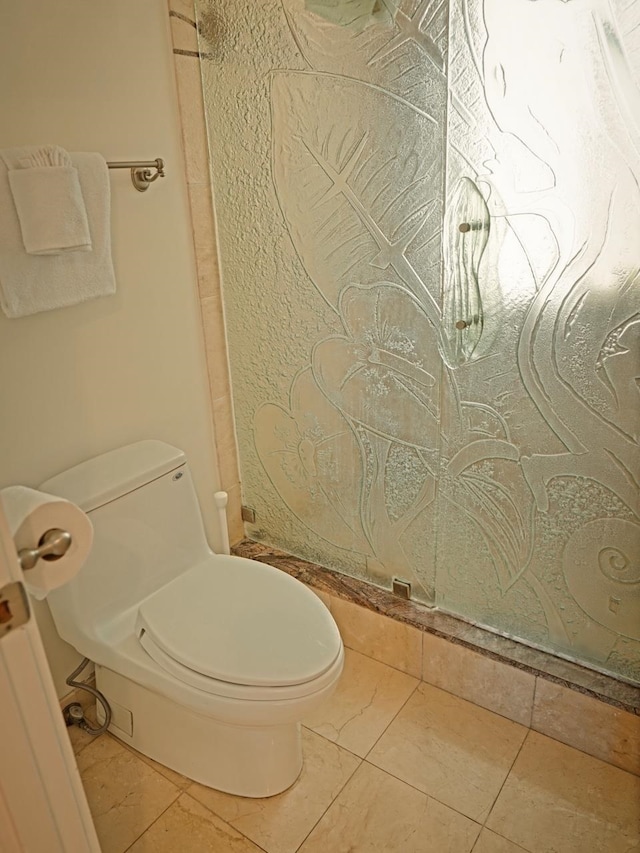 bathroom featuring tile floors and toilet