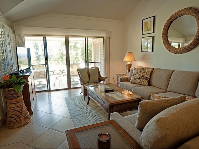 living room featuring tile flooring and vaulted ceiling