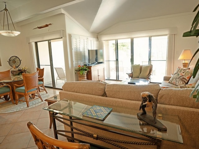 tiled living room with vaulted ceiling with beams and a healthy amount of sunlight