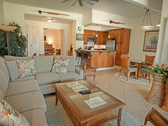 living room with ceiling fan and light tile flooring