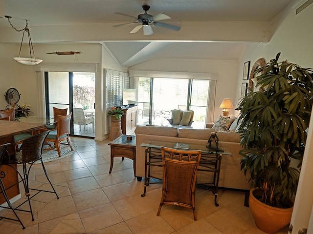 living room with a healthy amount of sunlight, ceiling fan, vaulted ceiling with beams, and light tile flooring