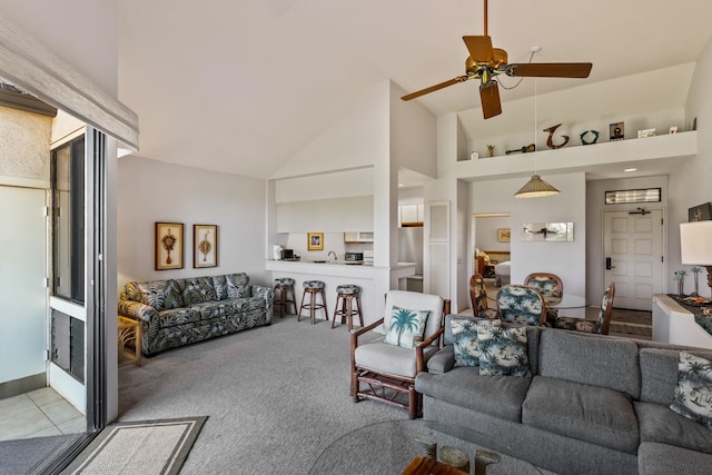 living area featuring ceiling fan, carpet floors, and high vaulted ceiling