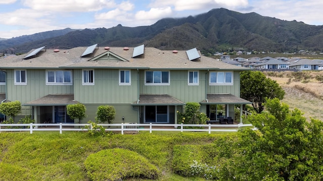 rear view of property featuring a mountain view