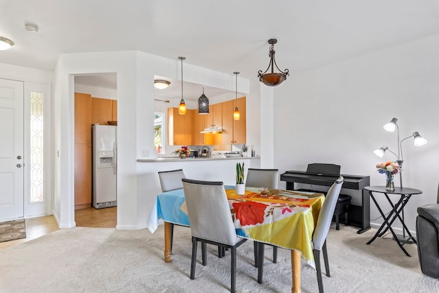 dining room with plenty of natural light and light carpet