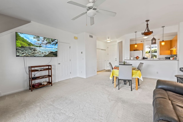 carpeted living room featuring ceiling fan