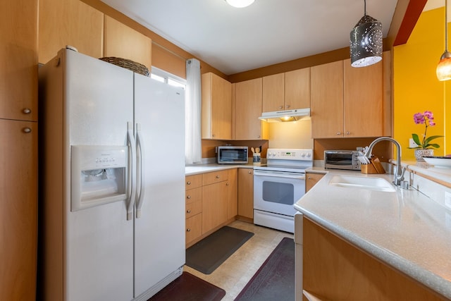 kitchen with pendant lighting, white appliances, sink, and light brown cabinetry