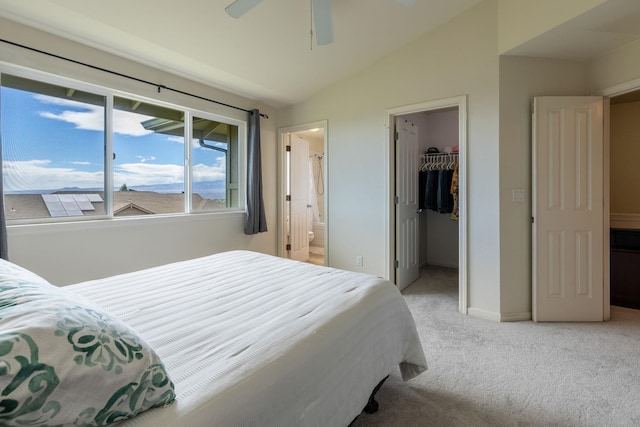 bedroom with lofted ceiling, connected bathroom, carpet floors, a spacious closet, and a closet