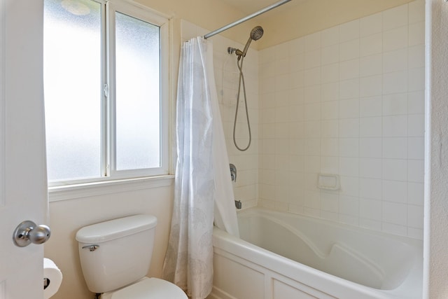 bathroom with shower / tub combo and toilet