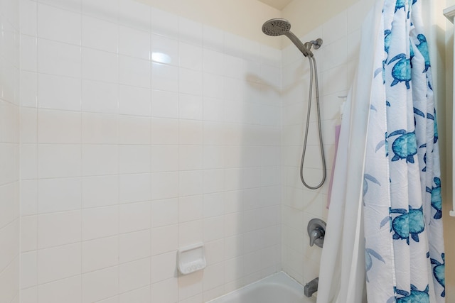 bathroom with shower / bath combination with curtain