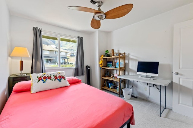 bedroom featuring light carpet and ceiling fan