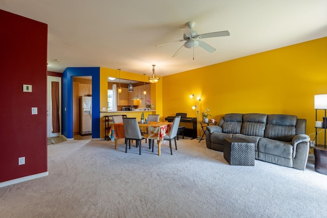 living room with ceiling fan and light carpet