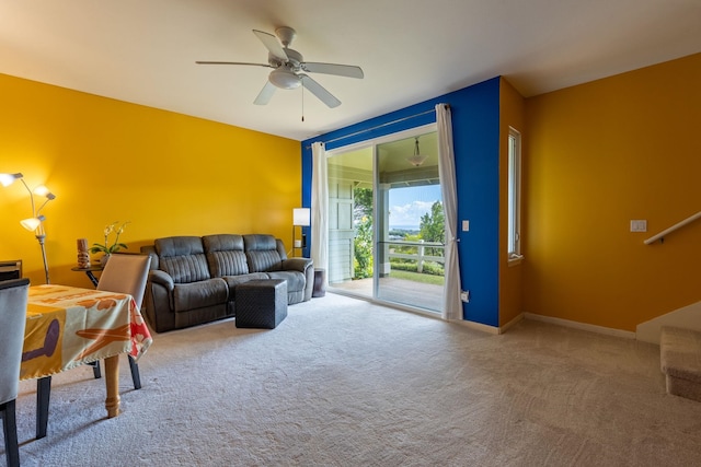 living room featuring carpet flooring and ceiling fan