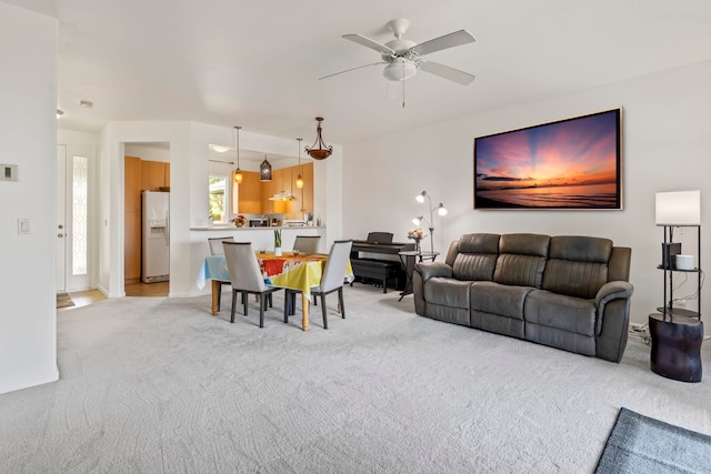 living room with ceiling fan and light colored carpet