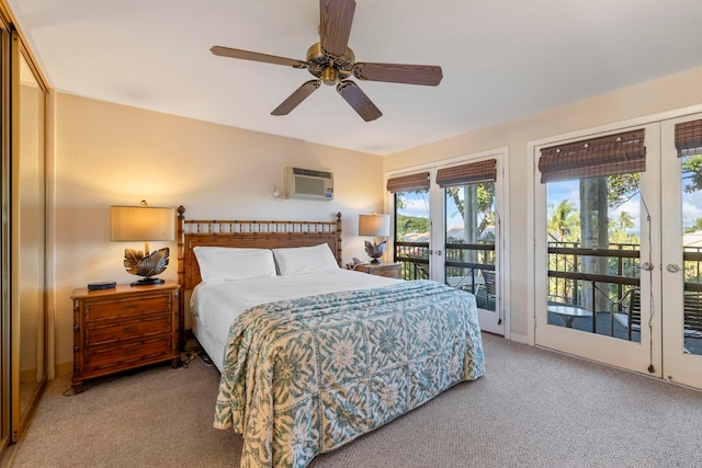 carpeted bedroom featuring access to outside, ceiling fan, and an AC wall unit