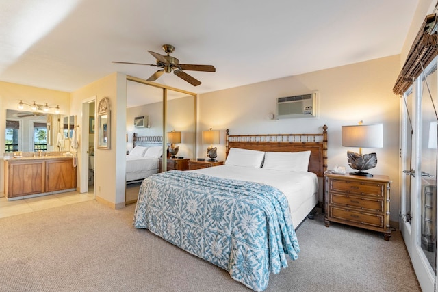 bedroom featuring ceiling fan, a closet, light colored carpet, and a wall mounted air conditioner