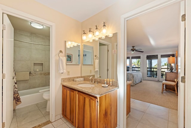 full bathroom with tile patterned floors, vanity, tiled shower / bath combo, ceiling fan, and toilet