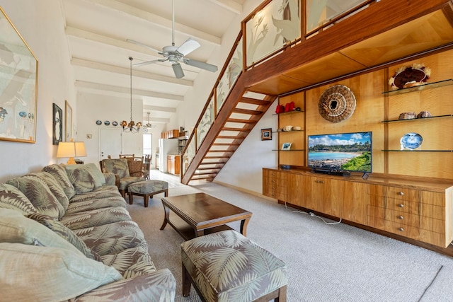 living room with carpet, beamed ceiling, ceiling fan with notable chandelier, and high vaulted ceiling