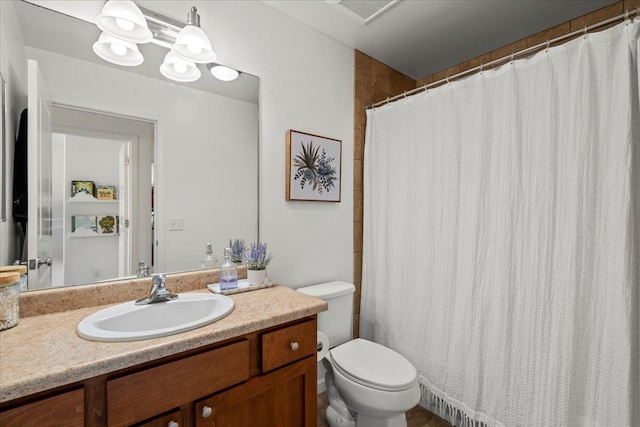 full bath featuring vanity, toilet, and visible vents