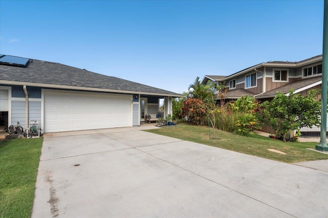 single story home with concrete driveway, a front yard, and a garage