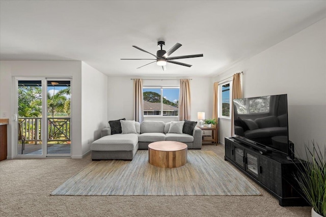 carpeted living room with ceiling fan