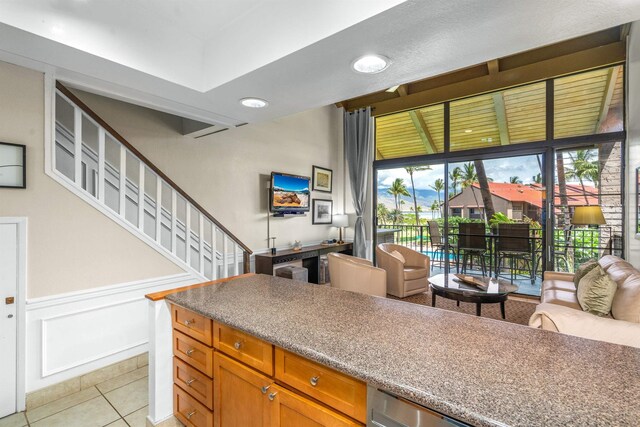 940 S Kihei Rd Unit C304, Kihei, HI 96753 - kitchen with brown cabinets, wainscoting, open floor plan, and light tile patterned floors