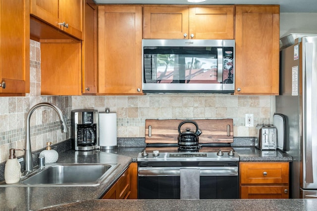 940 S Kihei Rd Unit C304, Kihei, HI 96753 - kitchen featuring appliances with stainless steel finishes, brown cabinetry, and dark countertops