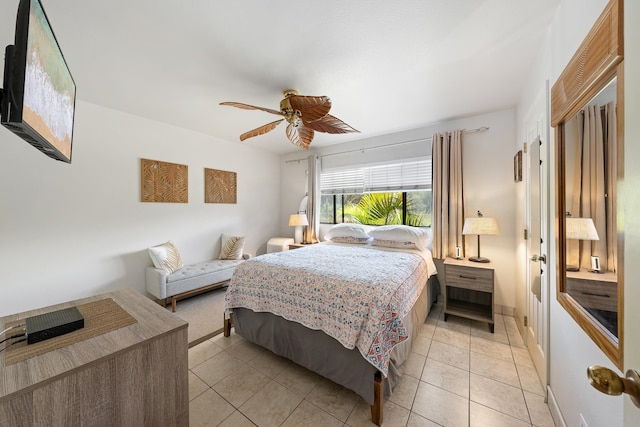 tiled bedroom featuring ceiling fan