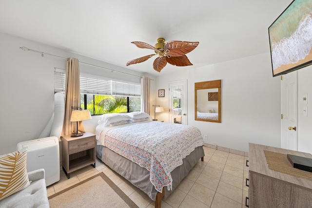 bedroom with ceiling fan and light tile patterned floors