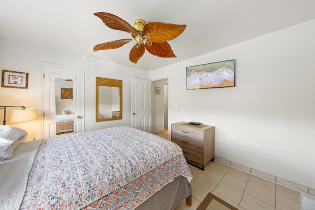 tiled bedroom with ceiling fan