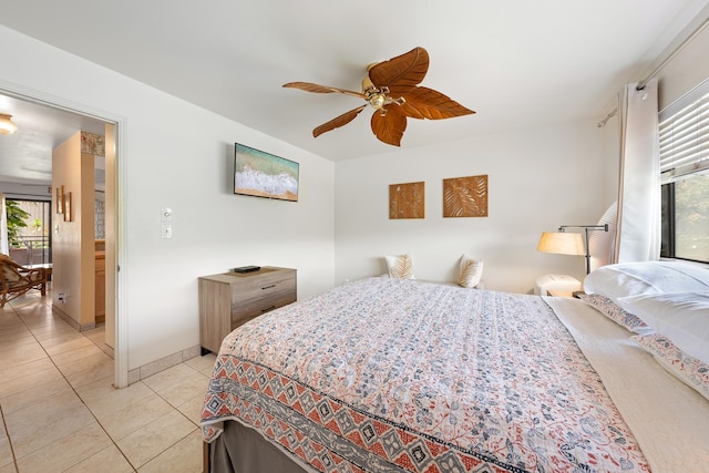 tiled bedroom featuring ceiling fan