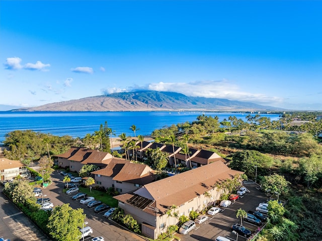 drone / aerial view with a water and mountain view