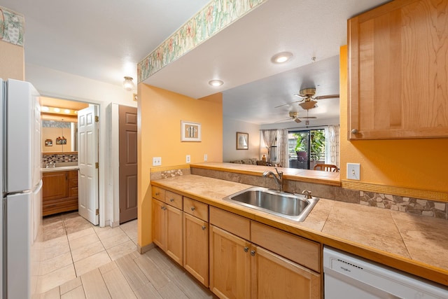 kitchen with sink, tile counters, white appliances, ceiling fan, and light tile patterned flooring