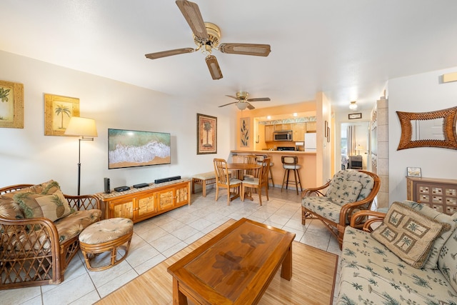 tiled living room with ceiling fan