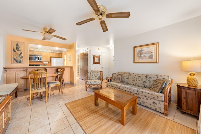 living room with ceiling fan and light tile patterned flooring