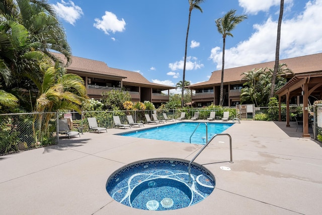 view of swimming pool with a community hot tub and a patio area