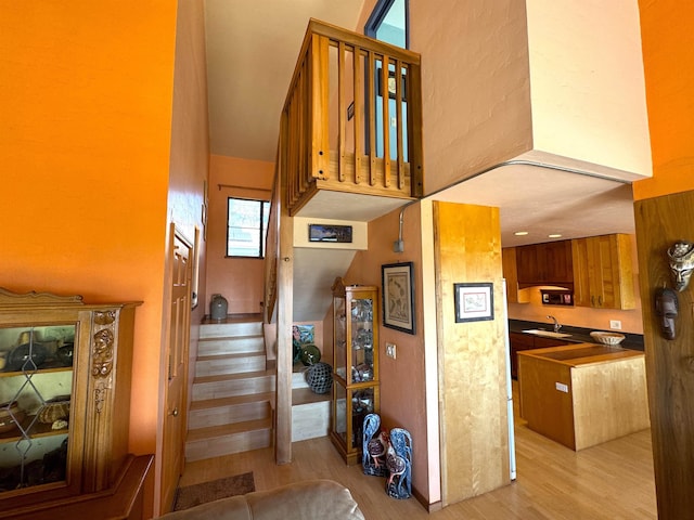 stairway featuring hardwood / wood-style floors and sink