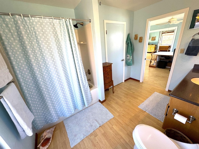 full bathroom featuring vanity, wood-type flooring, shower / tub combo, and toilet