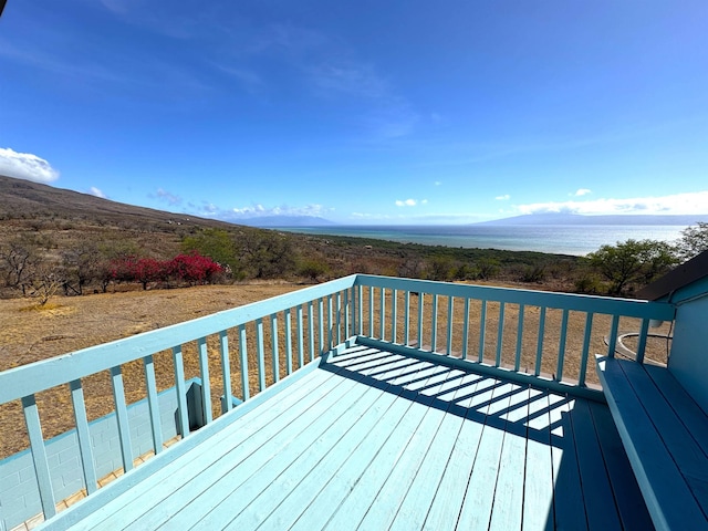 deck with a water and mountain view