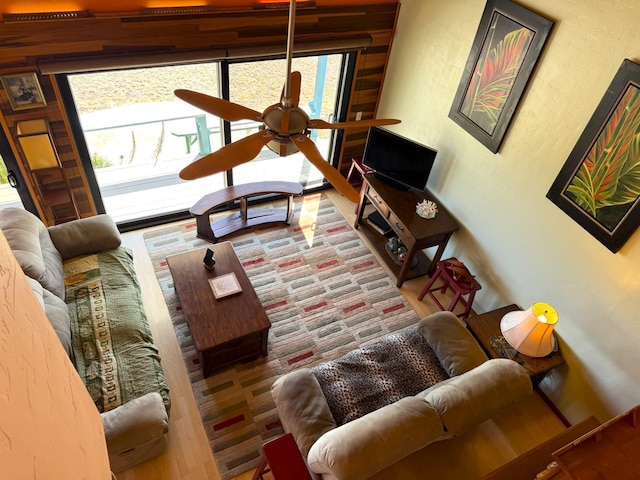 living room featuring ceiling fan and a healthy amount of sunlight