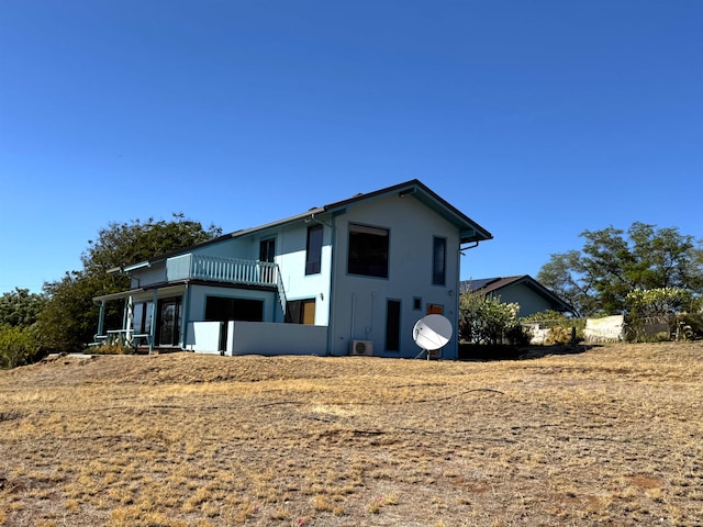 view of front of house featuring a sunroom and a balcony