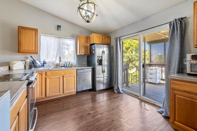 232 N Opio Pl Unit 232N, Opio Pl, Kihei, HI 96753 - kitchen with appliances with stainless steel finishes, lofted ceiling, a textured ceiling, dark wood finished floors, and light countertops