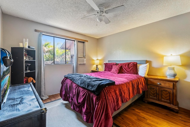 232 N Opio Pl Unit 232N, Opio Pl, Kihei, HI 96753 - bedroom with a textured ceiling, cooling unit, a ceiling fan, and wood finished floors