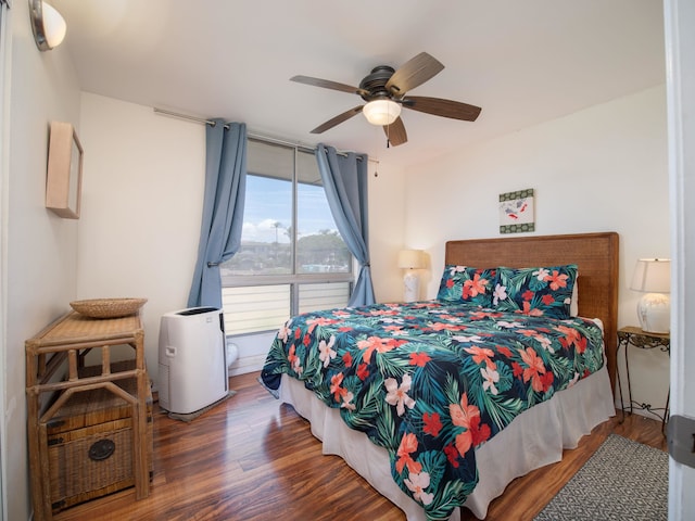 bedroom with ceiling fan and dark wood-type flooring