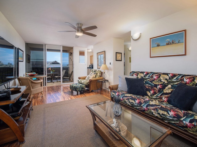 living room with floor to ceiling windows, ceiling fan, and hardwood / wood-style flooring