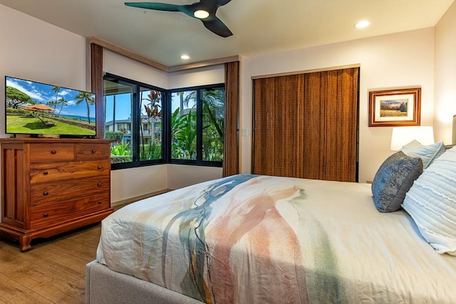 bedroom with a closet, ceiling fan, and wood-type flooring